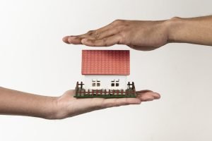 real estate agent client holding toy house