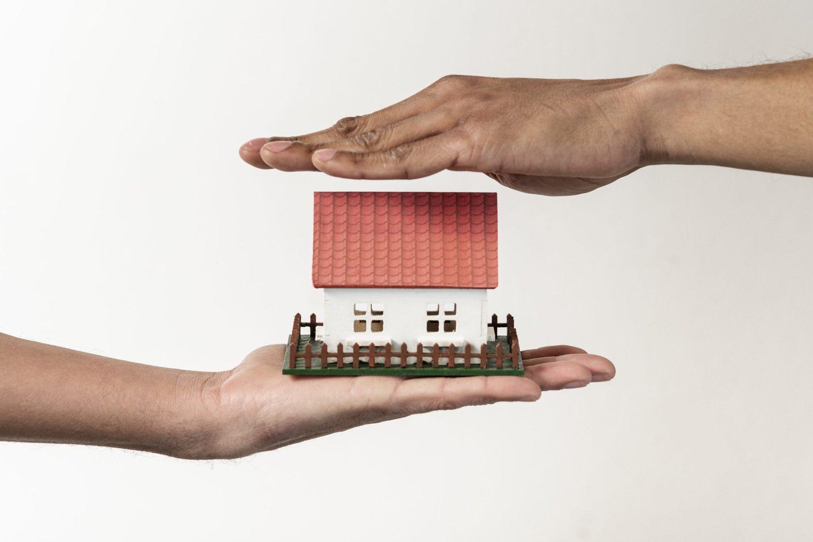 real estate agent client holding toy house